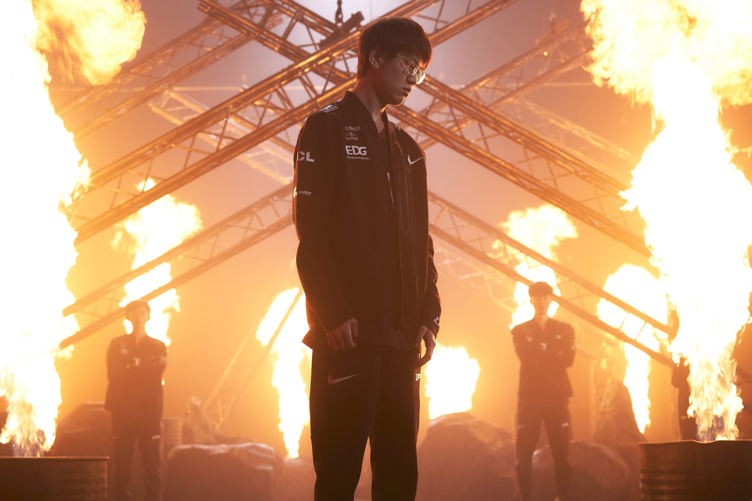 Meiko stands in front of EDG amidst fire