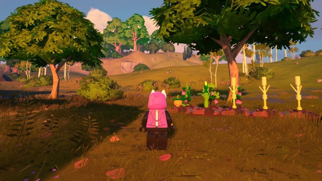 LEGO Fortnite character looking at a crop patch, with pumpkins, wheat, corn, and raspberries.